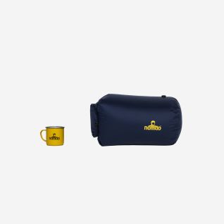 NOMAD waterproof stuff sack in dark blue next to a yellow NOMAD mug on a white background