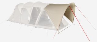 NOMAD Dogon 4 plus 2 Air Porch twill tent with spacious front porch and space for three people at a camping table.