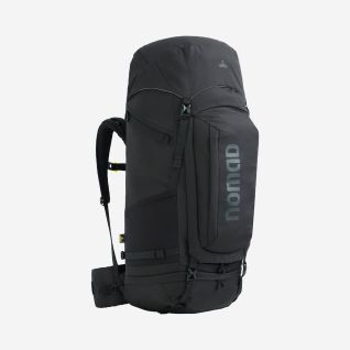 Man wearing a black NOMAD Batura 70 Premium backpack suitable for trekking and outdoor adventures.