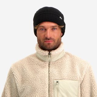 Man wearing a black NOMAD Turoa men's beanie with a knitted texture.