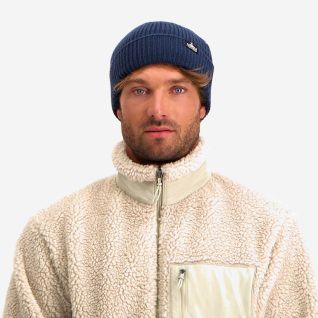 NOMAD Turoa men's dark blue knitted beanie with logo worn by a man