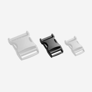 NOMAD black single-adjust buckle shown centrally between two transparent buckles for outdoor gear