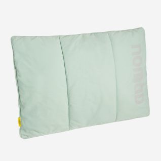 NOMAD Wollip multifunctional travel pillow in light blue with a visible logo.
