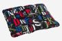 NOMAD Wollip multifunctional black travel pillow with colorful letters and prints on a rectangular design.