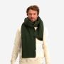 NOMAD Turoa men's scarf in dark green, chunky-knit, modeled by a man wearing a light sweater.