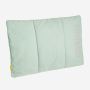 NOMAD Wollip multifunctional travel pillow in light blue with a visible logo.