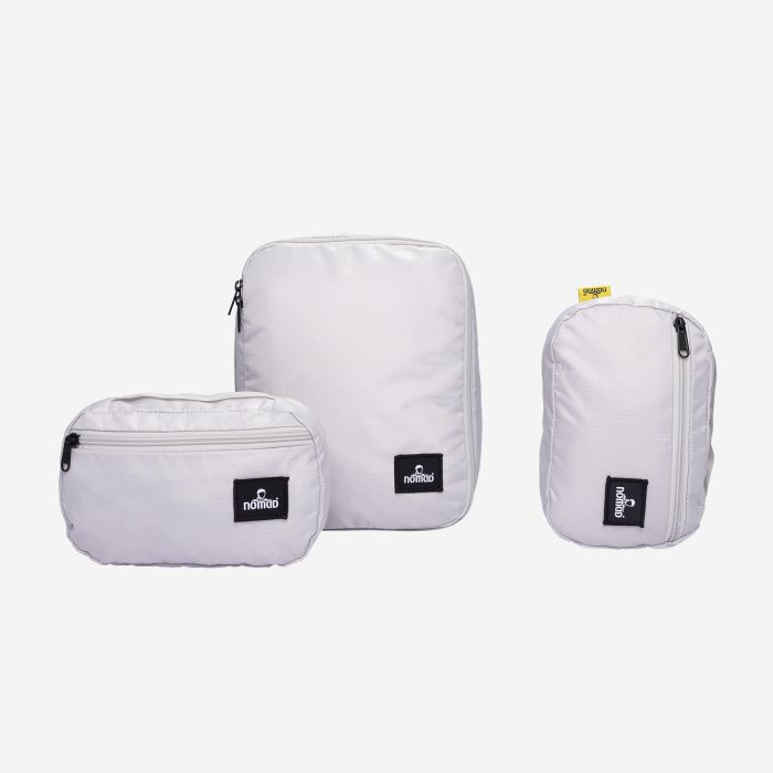 NOMAD premium packing cube set in vapor grey three light grey storage bags with zippers and logo