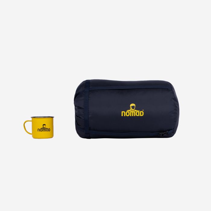 Dark blue NOMAD L/XL compression sack next to a yellow NOMAD mug on a white background.