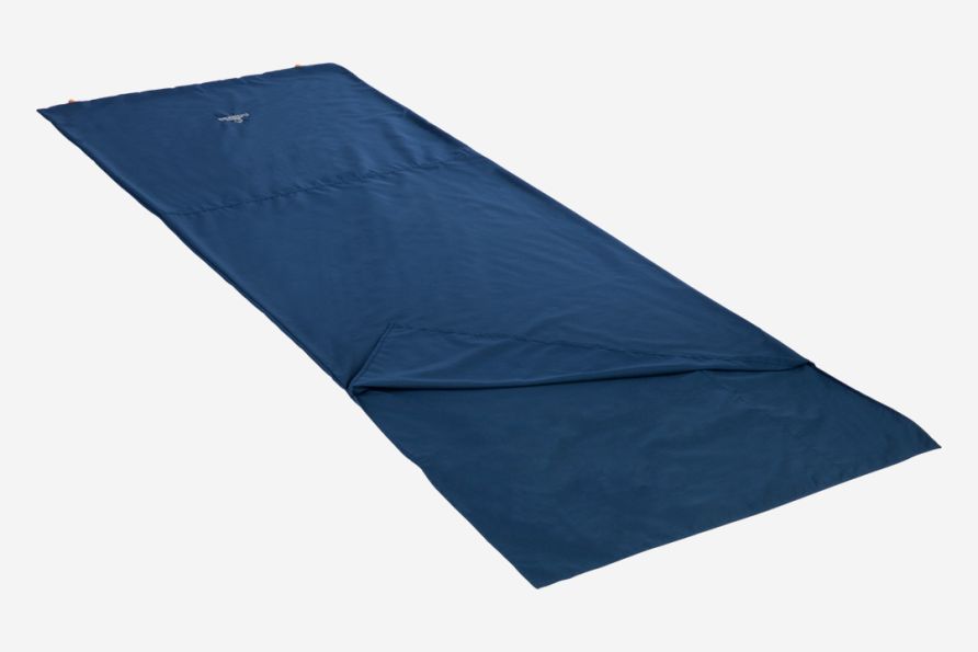 NOMAD travel sheet made of technical cotton in dark denim color, with a corner unfolded on a light background.