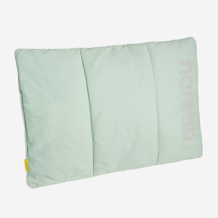NOMAD Wollip multifunctional travel pillow in light blue with a visible logo.
