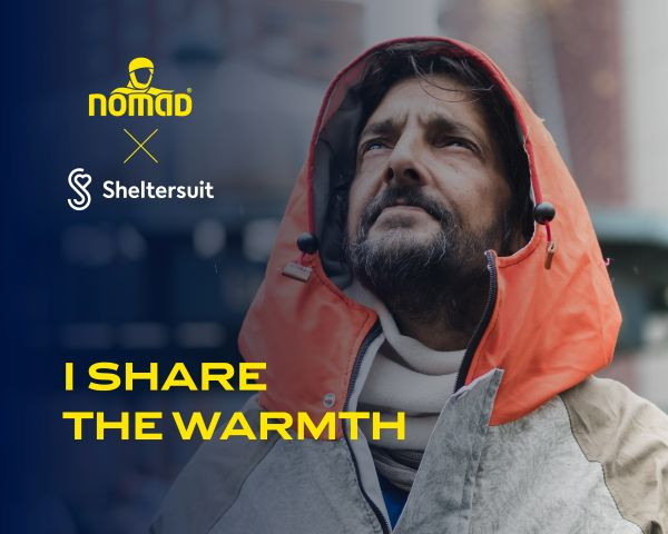 Man standing outside in rain, wearing warm jacket from collaboration between NOMAD and Sheltersuit